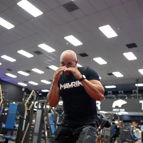 Boxer drinking from a MAVRIK bottle after training