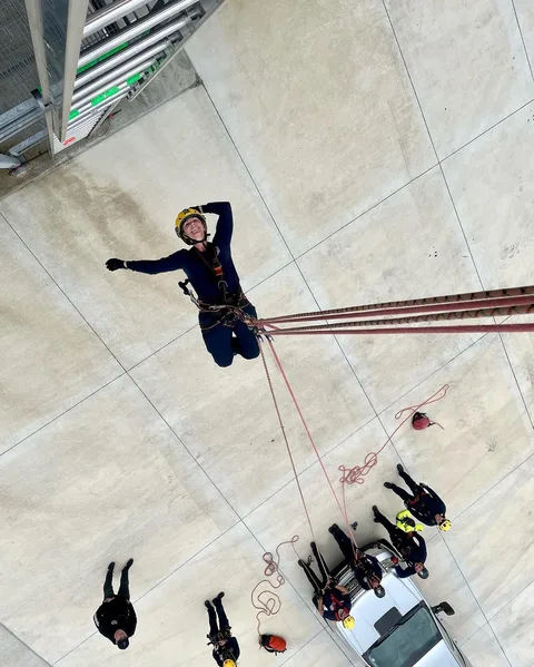 Firefighter descending a rappel line during training